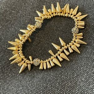 Lovely gold bracelet with spikes and crystal details!